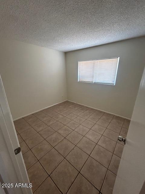 4625 W Thomas Rd Unit 48, Phoenix, AZ 85031 - unfurnished room featuring light tile patterned floors and a textured ceiling