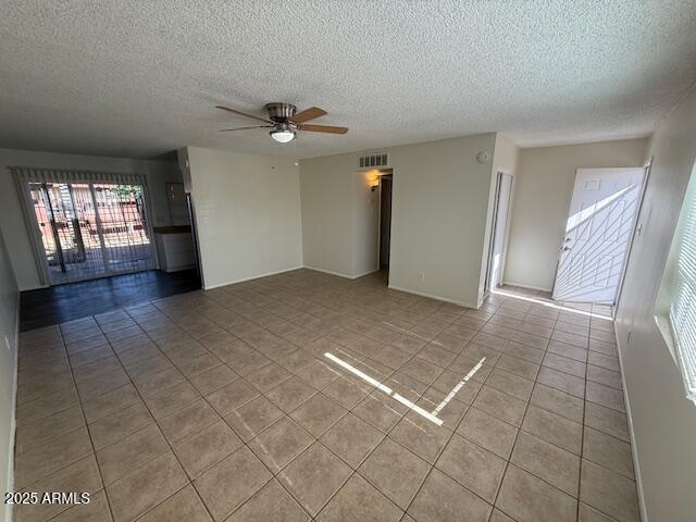 4625 W Thomas Rd Unit 48, Phoenix, AZ 85031 - empty room featuring light tile patterned floors, a ceiling fan, and a textured ceiling