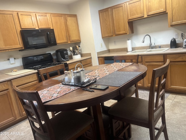 5220 W Mauna Loa Ln, Glendale, AZ 85306 - kitchen with black appliances, a sink, light countertops, and light tile patterned floors