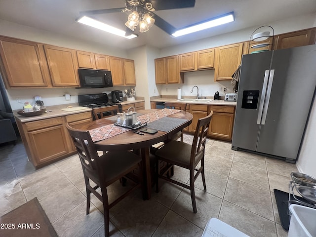 5220 W Mauna Loa Ln, Glendale, AZ 85306 - kitchen with black microwave, stainless steel fridge with ice dispenser, gas range, a sink, and a ceiling fan