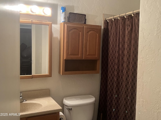 5220 W Mauna Loa Ln, Glendale, AZ 85306 - bathroom featuring a textured wall, toilet, vanity, and curtained shower