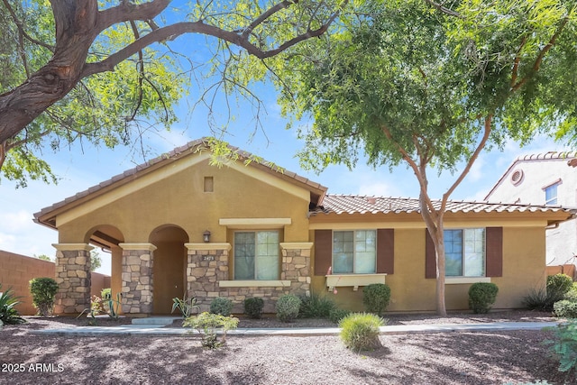2475 E Vermont Dr, Gilbert, AZ 85295 - view of front of property featuring a tiled roof, stone siding, stucco siding, and fence