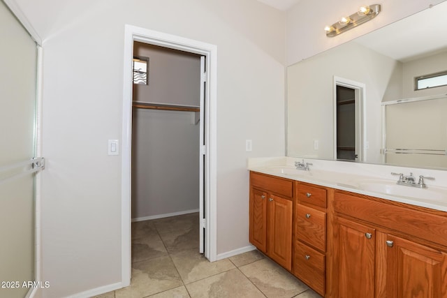2475 E Vermont Dr, Gilbert, AZ 85295 - full bath with a walk in closet, double vanity, tile patterned flooring, an enclosed shower, and baseboards