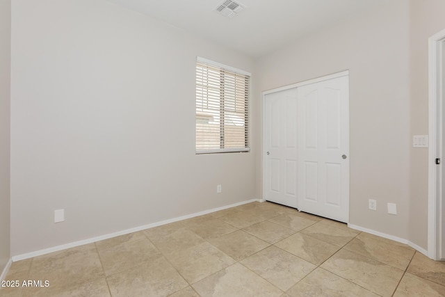 2475 E Vermont Dr, Gilbert, AZ 85295 - unfurnished bedroom with baseboards, a closet, and light tile patterned flooring