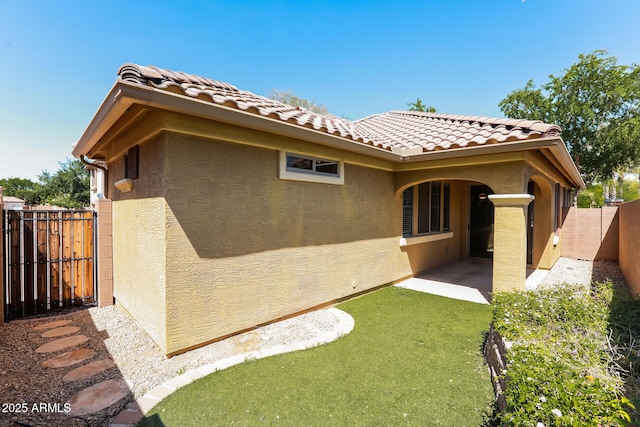 2475 E Vermont Dr, Gilbert, AZ 85295 - rear view of property featuring stucco siding, a fenced backyard, a tile roof, and a patio area