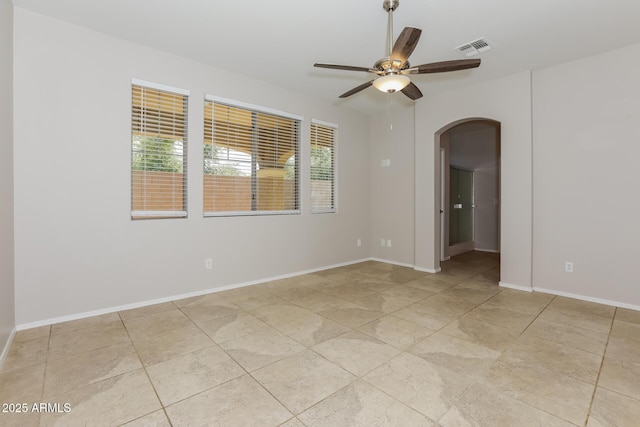 2475 E Vermont Dr, Gilbert, AZ 85295 - spare room featuring arched walkways, ceiling fan, and baseboards