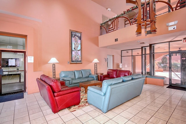 living room featuring a high ceiling and light tile patterned floors