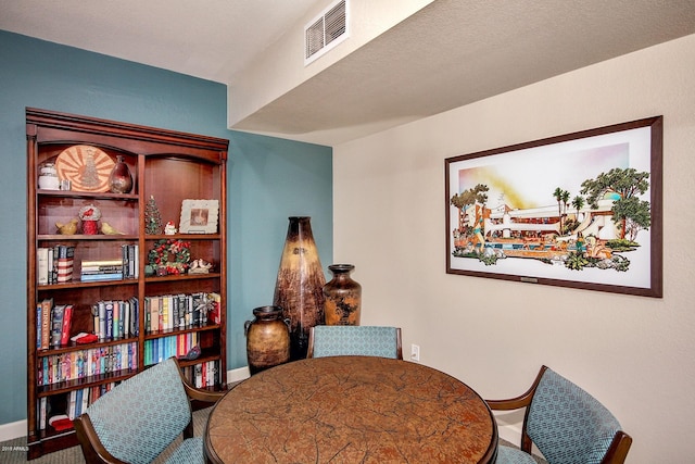 dining area featuring a textured ceiling