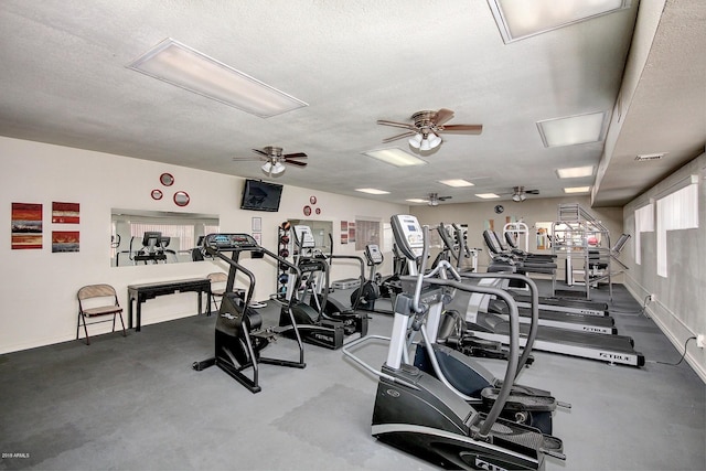 gym with a textured ceiling and ceiling fan