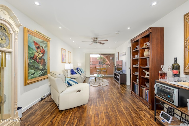 living room with ceiling fan and dark hardwood / wood-style floors