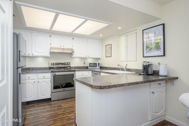 kitchen featuring dark hardwood / wood-style flooring, white cabinetry, sink, and appliances with stainless steel finishes