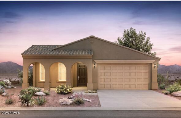 13512 W Copperleaf Ln, Peoria, AZ 85383 - view of front facade featuring concrete driveway, stucco siding, an attached garage, and a mountain view