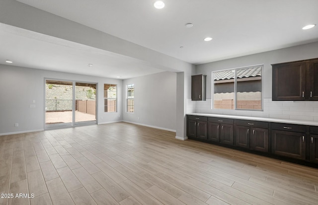 13512 W Copperleaf Ln, Peoria, AZ 85383 - unfurnished living room with light wood finished floors and recessed lighting