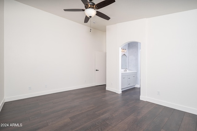 spare room featuring dark hardwood / wood-style floors, ceiling fan, and sink