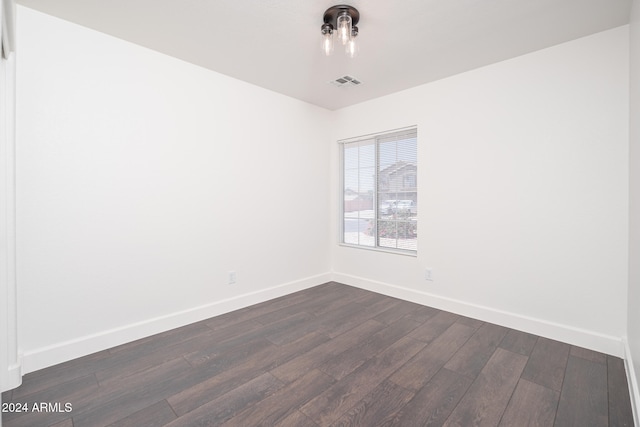 unfurnished room featuring dark hardwood / wood-style flooring