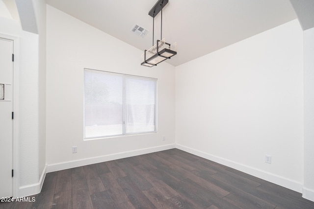 unfurnished dining area featuring dark hardwood / wood-style floors and lofted ceiling