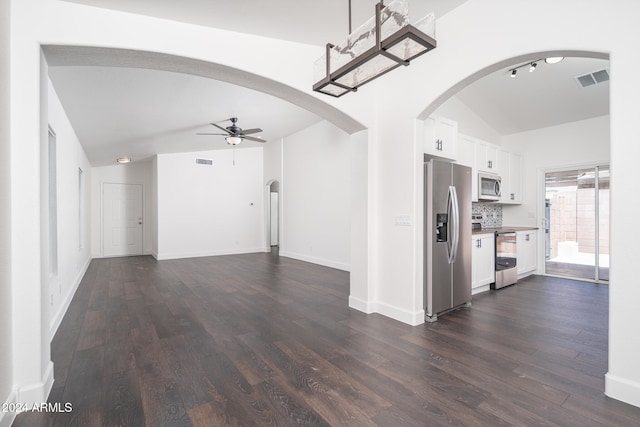 unfurnished living room featuring dark hardwood / wood-style flooring, ceiling fan, and lofted ceiling