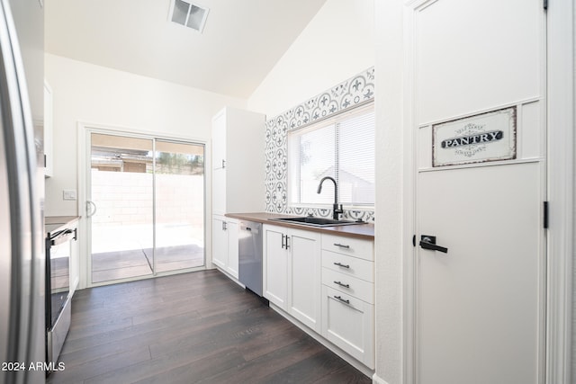 kitchen featuring white cabinets, appliances with stainless steel finishes, a wealth of natural light, and sink