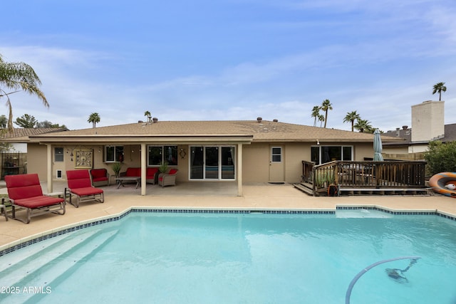 view of pool featuring a fenced in pool, a patio, and a wooden deck
