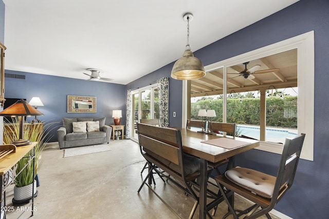 dining room featuring concrete floors, ceiling fan, and visible vents