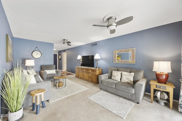 living room featuring concrete floors, visible vents, and ceiling fan