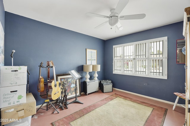 interior space with baseboards and a ceiling fan