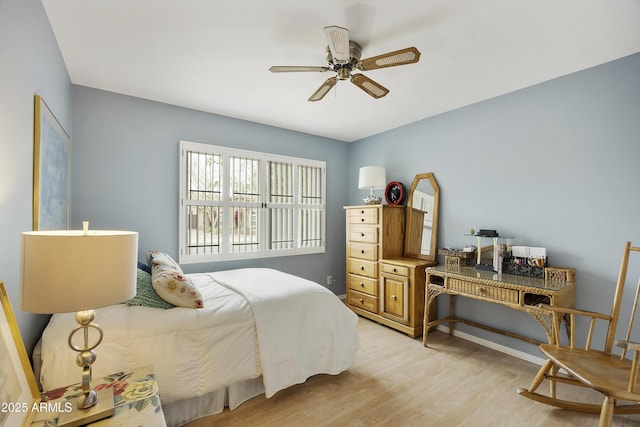 bedroom with ceiling fan and light wood-style flooring