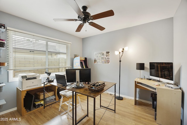 home office featuring baseboards, light wood-style floors, and ceiling fan