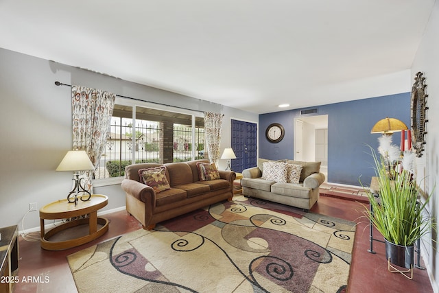 living room featuring baseboards and visible vents