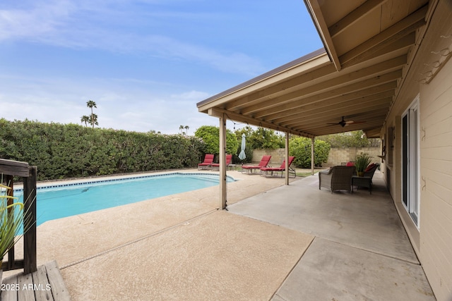 view of swimming pool with a fenced backyard, a fenced in pool, ceiling fan, and a patio