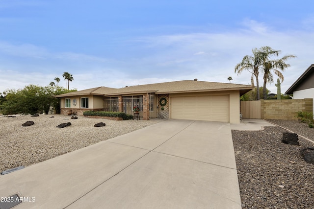 single story home featuring driveway, an attached garage, and fence