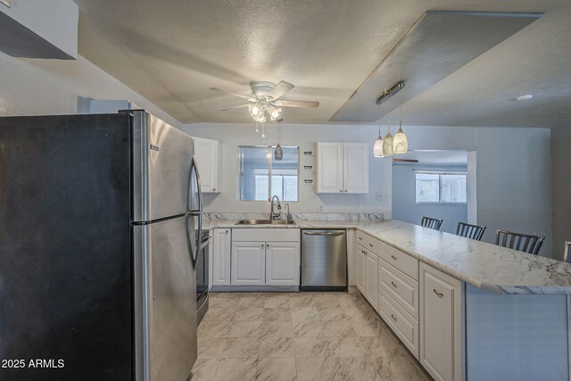 5657 E Dallas St, Mesa, AZ 85205 - kitchen featuring appliances with stainless steel finishes, a sink, a peninsula, white cabinets, and a ceiling fan
