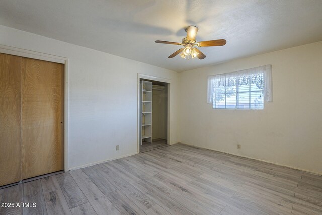 5657 E Dallas St, Mesa, AZ 85205 - unfurnished bedroom featuring wood finished floors, multiple closets, ceiling fan, and baseboards