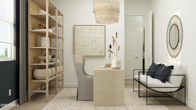 living area with carpet floors, baseboards, and a chandelier