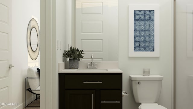 bathroom featuring vanity and toilet