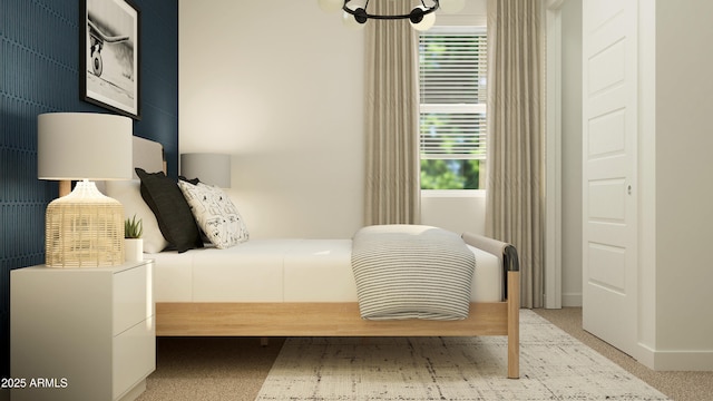 bedroom with carpet floors and a notable chandelier