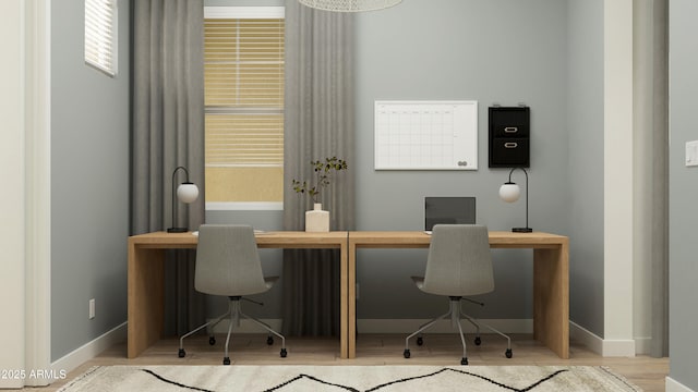 office area with baseboards and wood finished floors