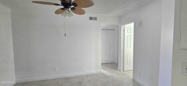 unfurnished room with a textured ceiling and ceiling fan