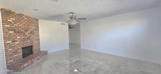 unfurnished living room with ceiling fan, a textured ceiling, and a fireplace