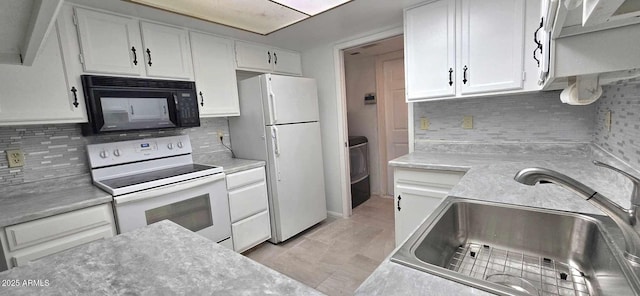 kitchen with white cabinetry, sink, white appliances, and tasteful backsplash