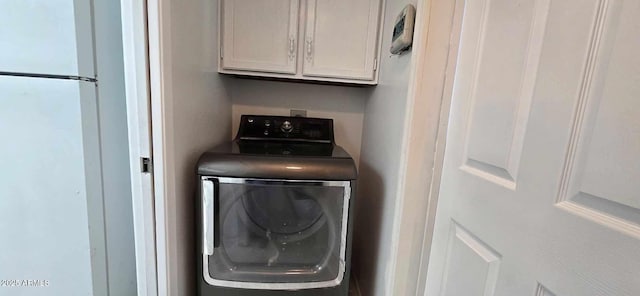 washroom featuring cabinets and washer / clothes dryer