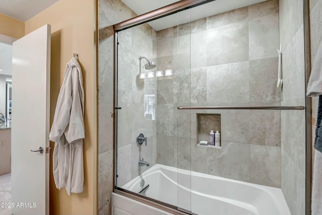 bathroom featuring shower / bath combination with glass door