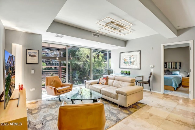 living room featuring floor to ceiling windows