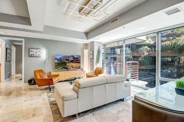 living room featuring floor to ceiling windows