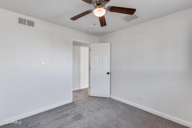 empty room with ceiling fan and carpet