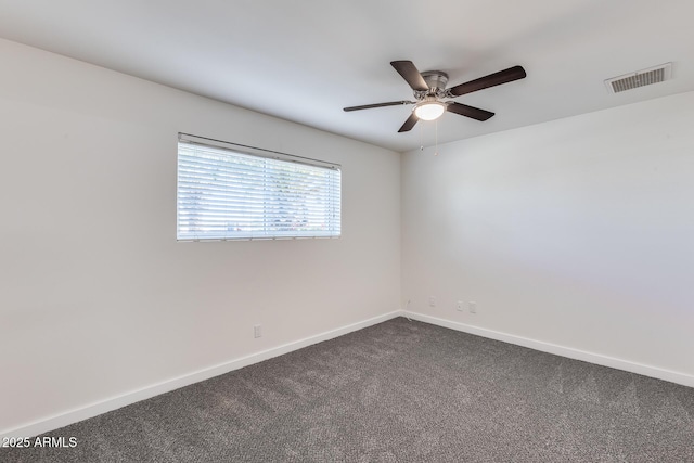 spare room with ceiling fan and carpet