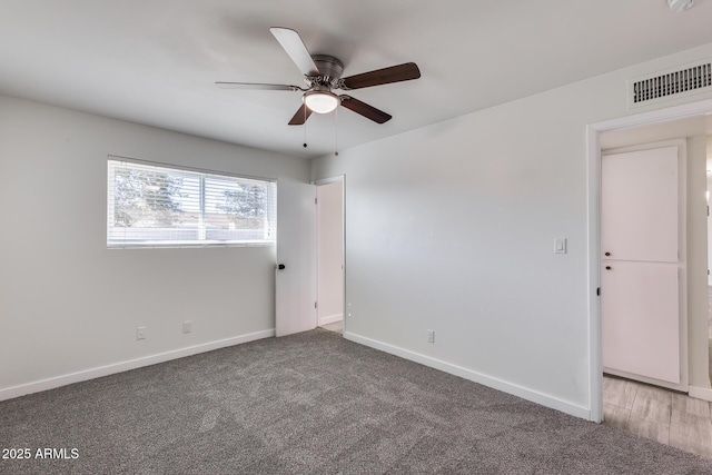 carpeted spare room with ceiling fan