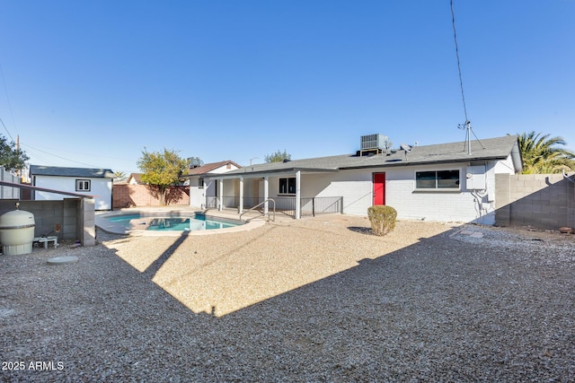 back of house with a patio, central AC unit, and a fenced in pool