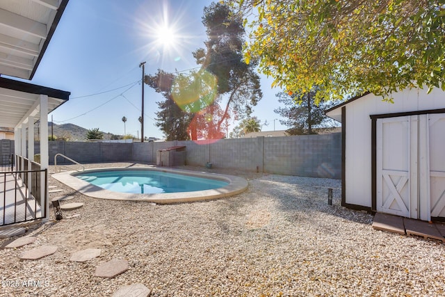 view of swimming pool with a storage unit