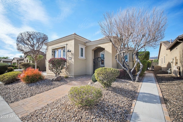 view of front facade featuring a residential view, a gate, and stucco siding